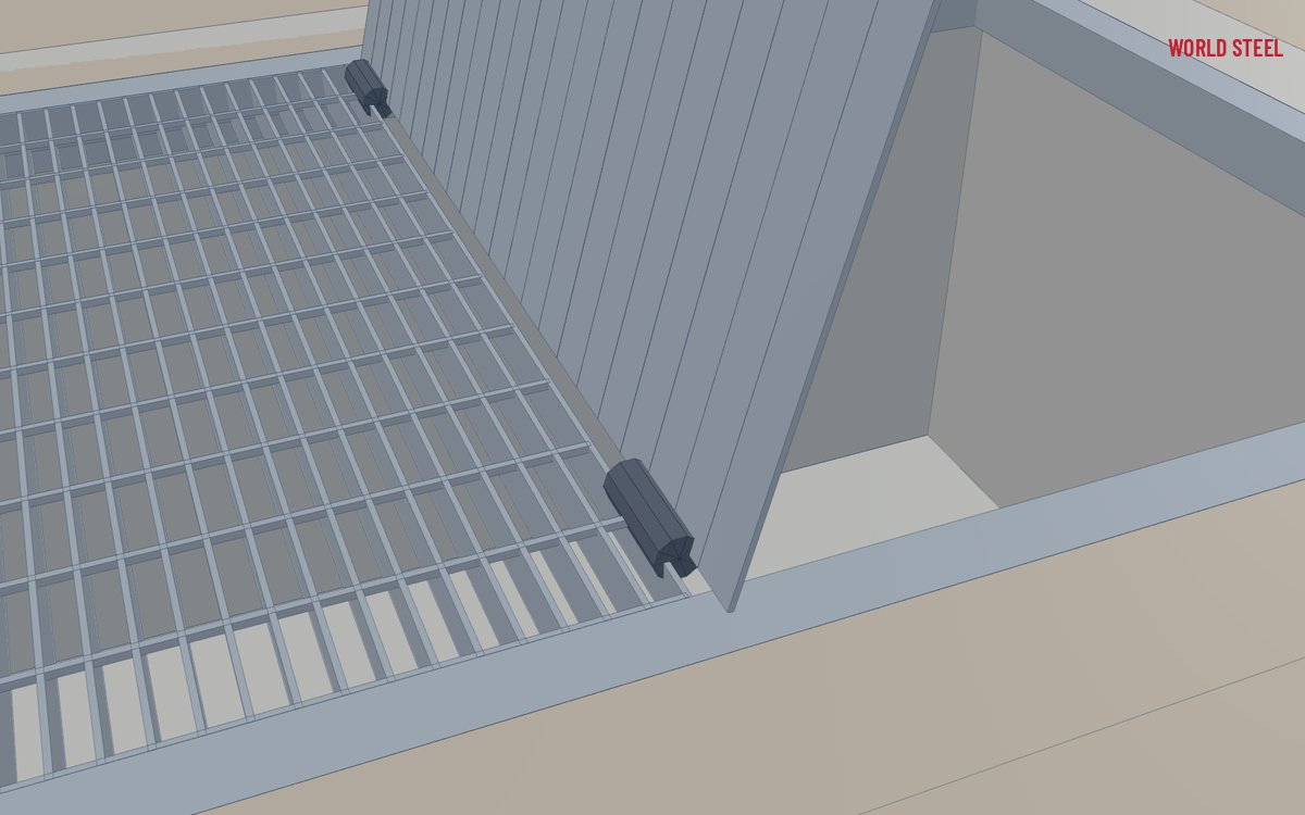 Close-up of a hinge and locking lug on a fabricated drainage grate