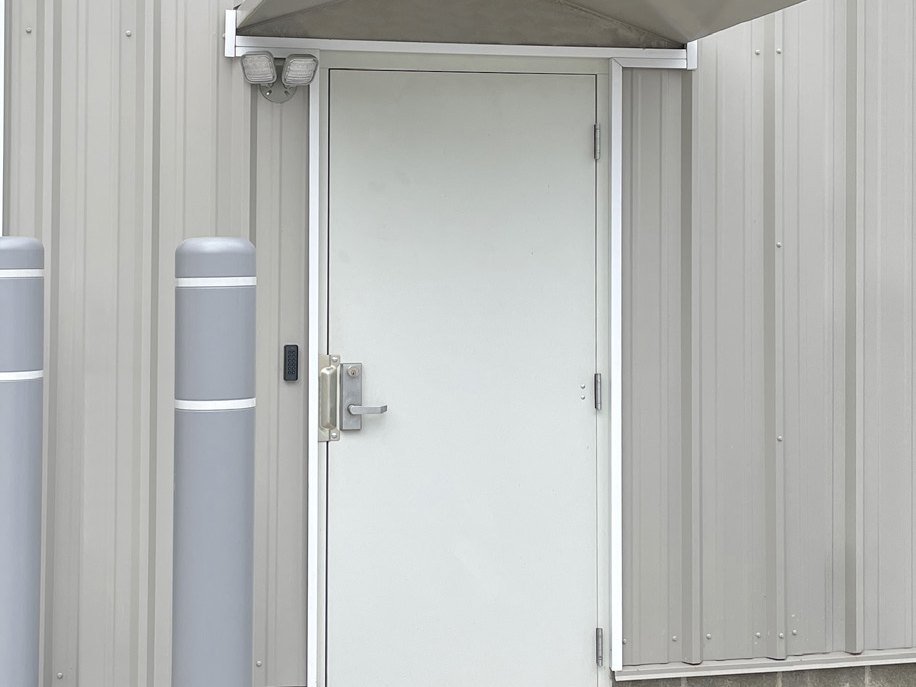 Pre-assembled walk door in a metal building wall